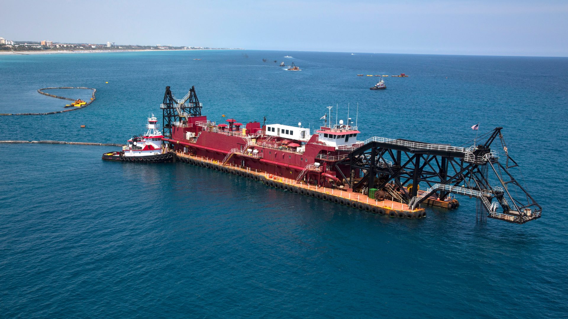 Dredger working offshore with a tug alongside