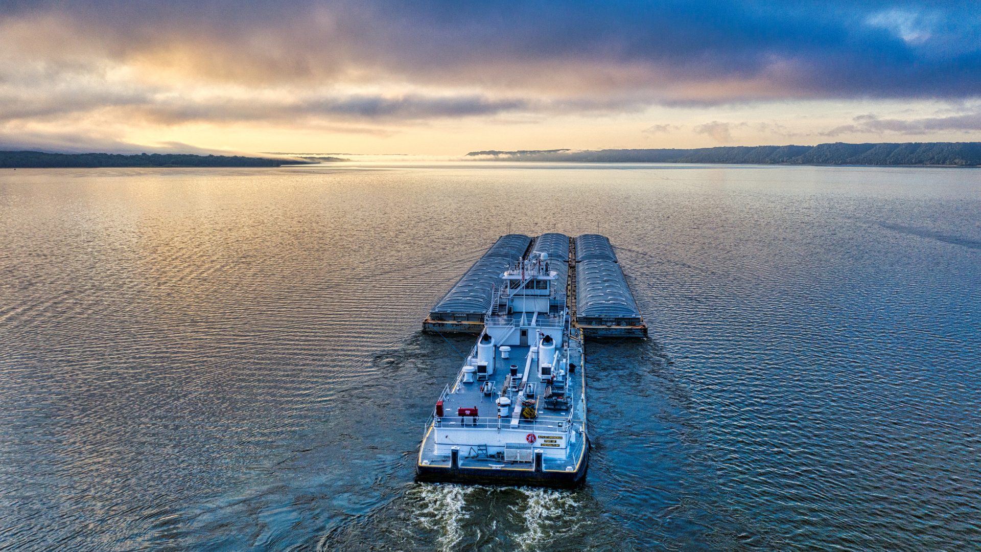 Push boat and barges at sunrise